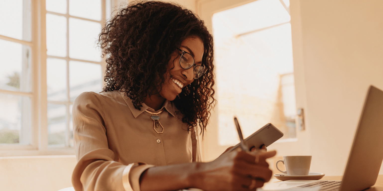 A businesswoman uses her online devices to learn EDI so her small business can fulfil its EDI mandate from its large trading partner.