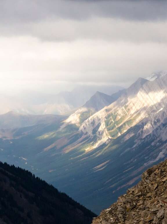 Hiker atop mountain overlooking view. Supply chain integration for increased visibility