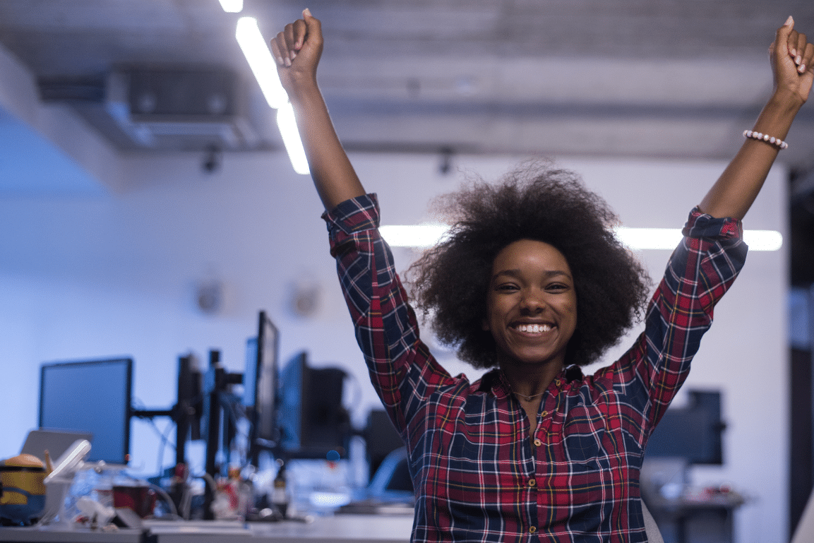 A SME businesswoman cheers as she uses Transalis' EDI beginner's guide to learn how EDI works