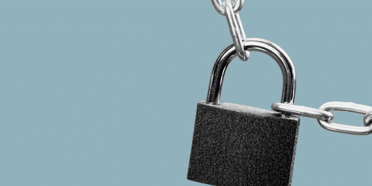 cut out image of a lock on a chain with a plain grey-blue background
