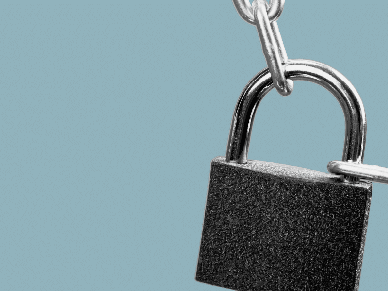 cut out image of a lock on a chain with a plain grey-blue background