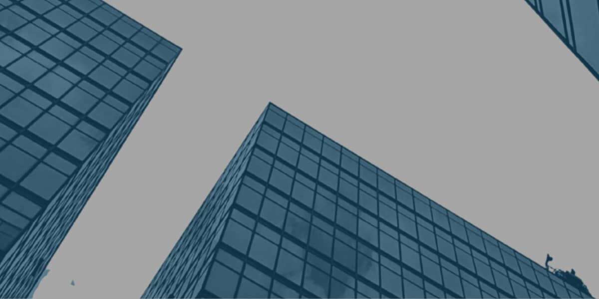 Cut out images of high-rise building with blue overlay colour, on a grey background. Representing the cover of Transalis' report; Achieving a frictionless supply chain for B2B