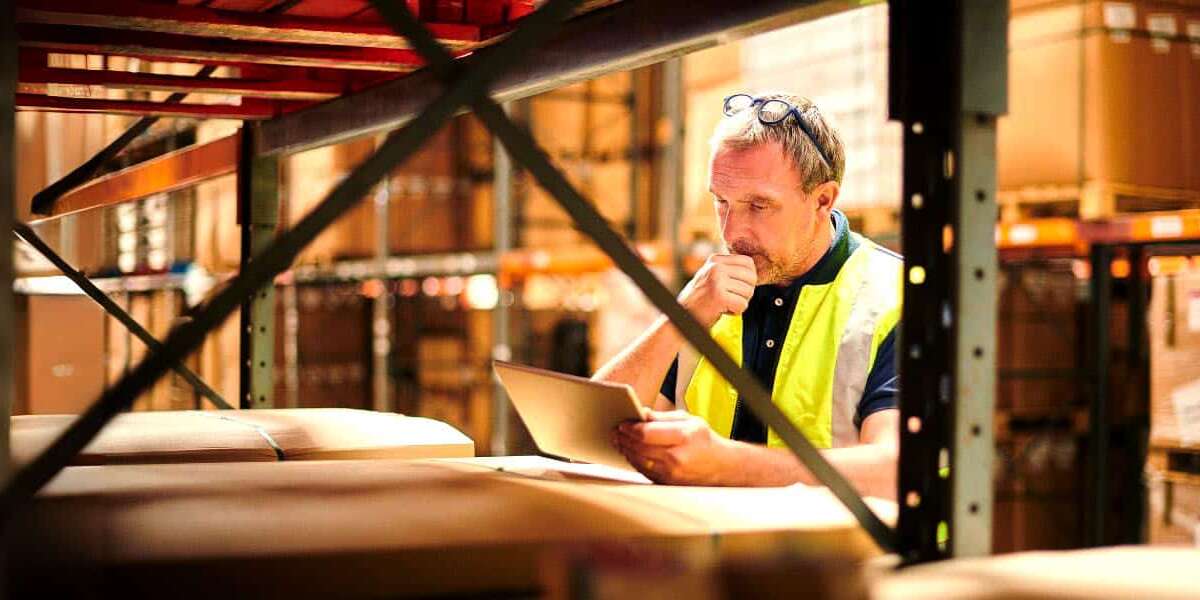 Blog-Headers Man reading ipad in warehouse