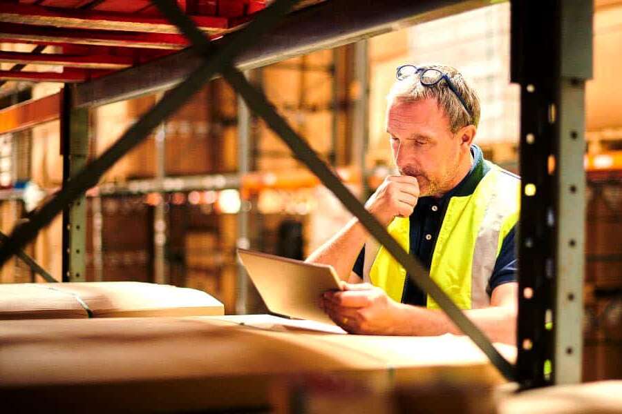 Blog-Headers Man reading ipad in warehouse