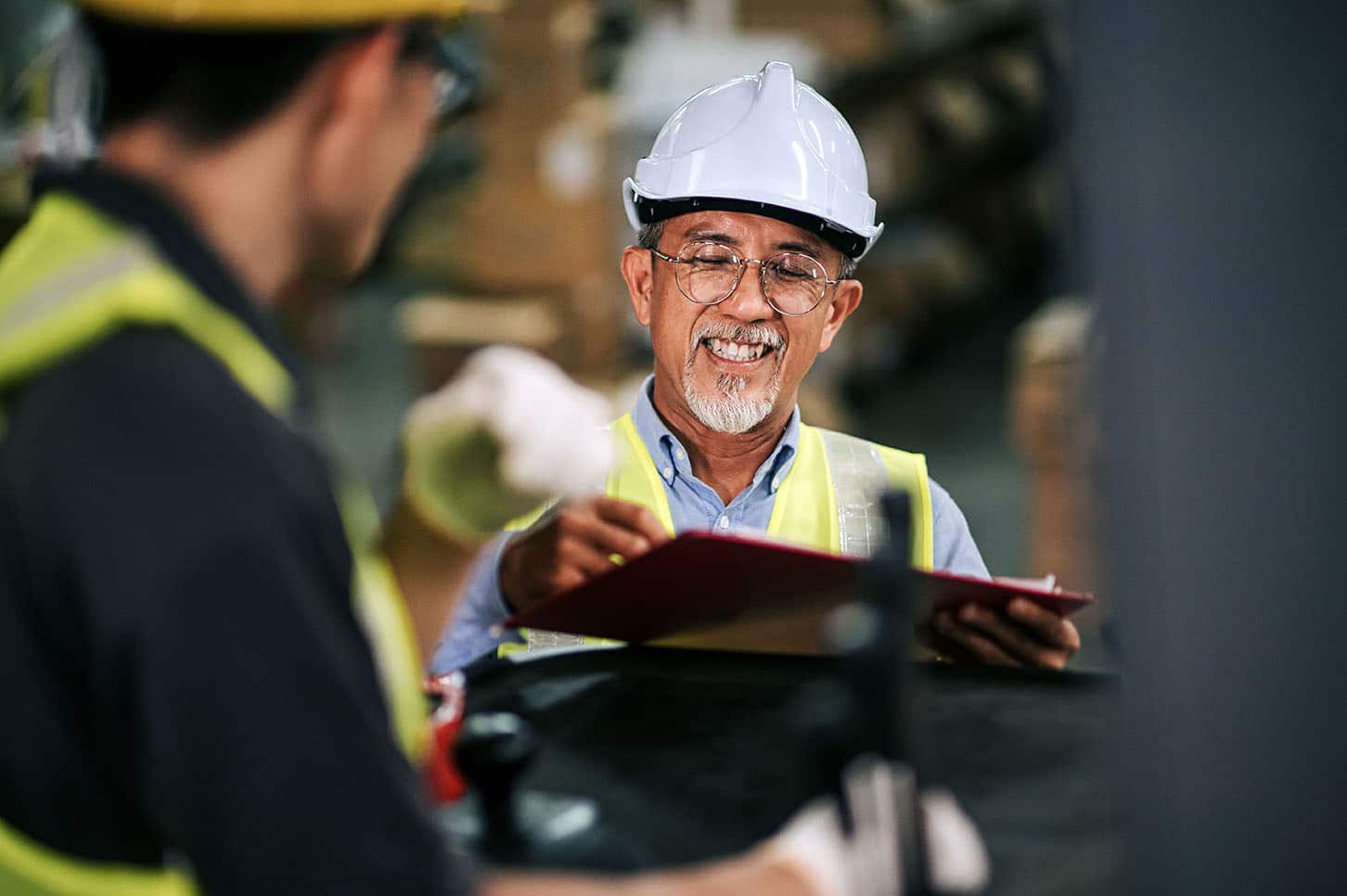 Man with clipboard in warehouse