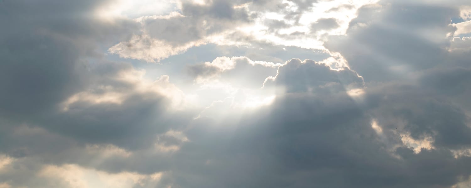 Cloudy grey sky with sunbeams. Used as a header image for a blog post titled: Doing EDI differently: Transalis launches new cloud EDI solutions