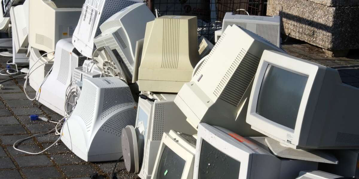 Piles of old, ugly and bulky desktop computers on a pavement. Representing Transalis blog post titled: How legacy EDI is holding you back