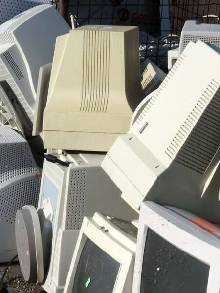 Piles of old, ugly and bulky desktop computers on a pavement. Representing Transalis blog post titled: How legacy EDI is holding you back
