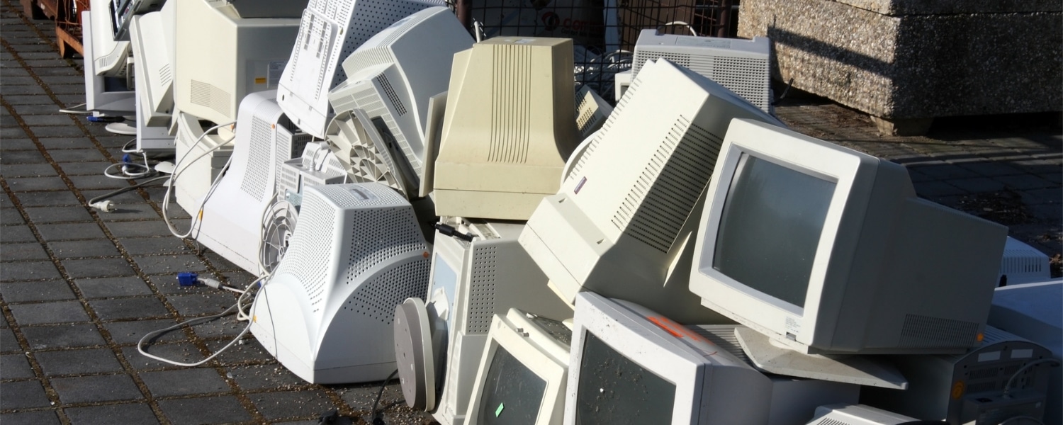 Piles of old, ugly and bulky desktop computers on a pavement. Representing Transalis blog post titled: How legacy EDI is holding you back